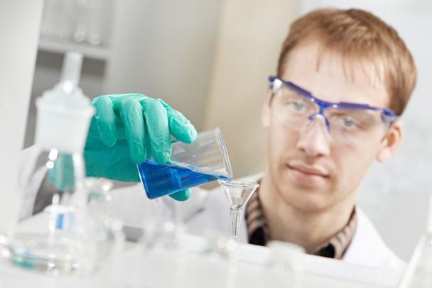 Man chemist scientist researcher in laboratory - Photo, Image