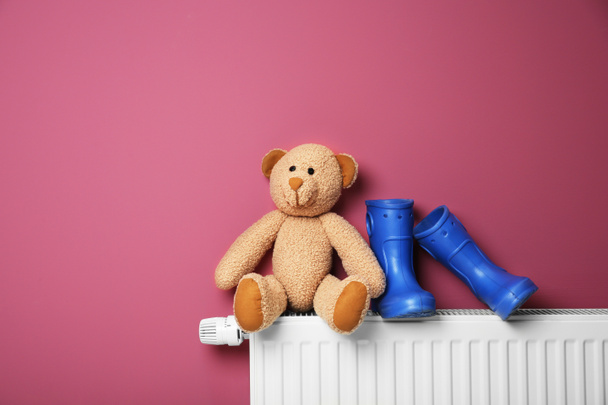 Teddy bear on heating radiator - Zdjęcie, obraz