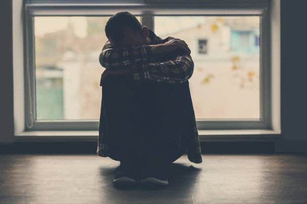 Depressed man sitting on floor - Φωτογραφία, εικόνα