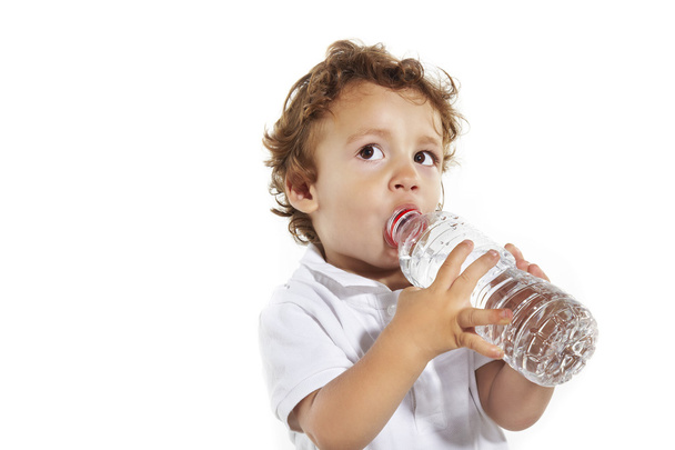 Portrait of the boy drinking water from a bottle. - Foto, afbeelding