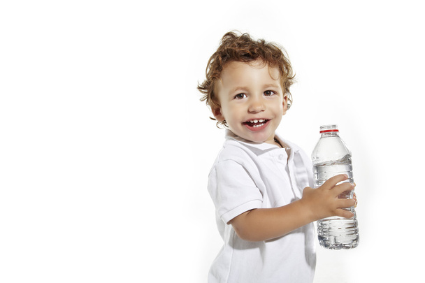 Portrait of a cute boy having a bottle of refreshing water - isolated on white background - Foto, afbeelding