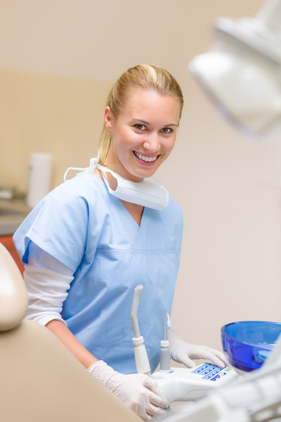Smiling dental practitioner prepare medical tools - Fotó, kép