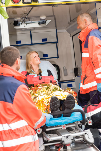 Emergency doctor with woman in ambulance - Фото, изображение