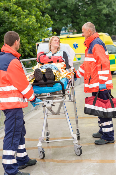 Injured woman talking with paramedics emergency - 写真・画像