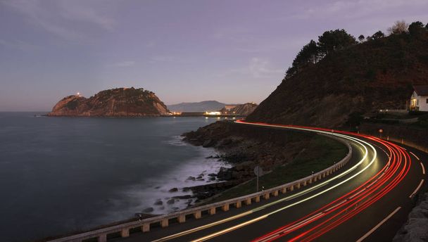 Car lights on the road near the coast, Getaria, Basque country - Foto, imagen
