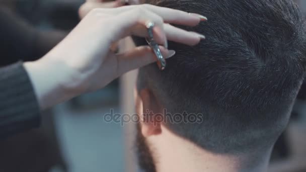 Female haircutter cutting the male hair in the barbershop 4K - Felvétel, videó