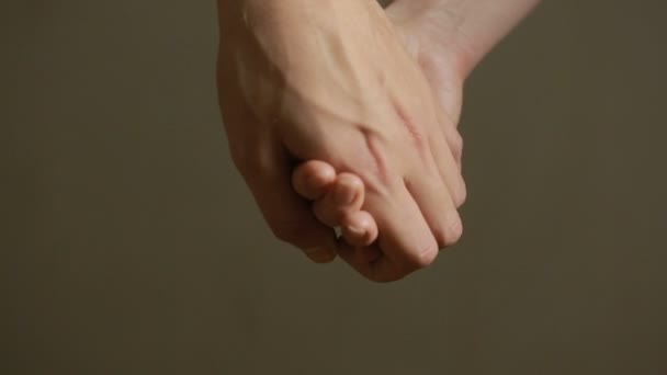 close up man and woman hand touching holding together on blurred background. - Footage, Video