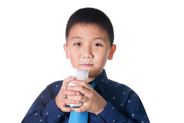 Boy drinking milk with milk mustache holding glass of milk isola - Zdjęcie, obraz