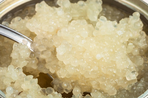 salty white caviar of halibut fish with spoon - Photo, Image