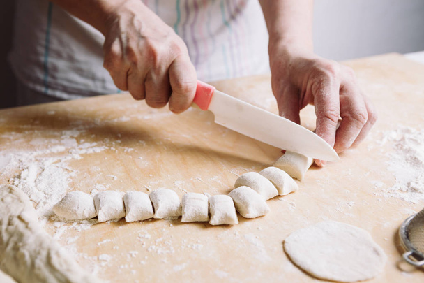 Two hands making dough for meat dumplings. - Foto, immagini