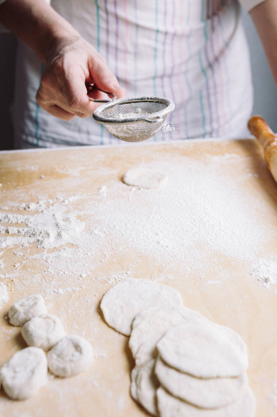 Two hands making dough for meat dumplings. - Foto, Bild