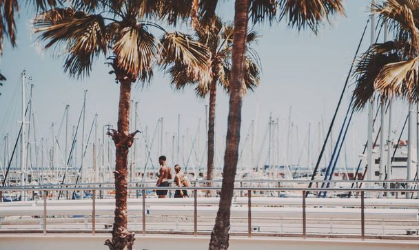 Couple walking near seafront near beach in Barcelona - Zdjęcie, obraz