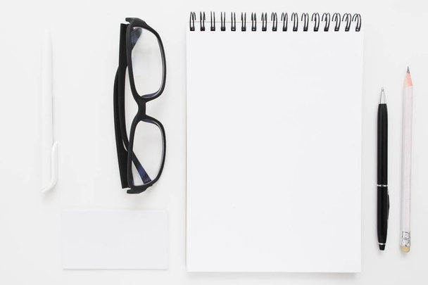 Blank notebook with stationery and glasses mockup - 写真・画像