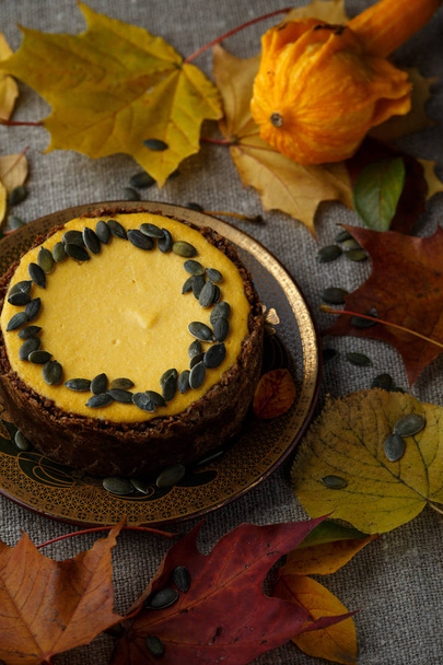 Delicious pumkin cake with leaves on background. - Foto, immagini