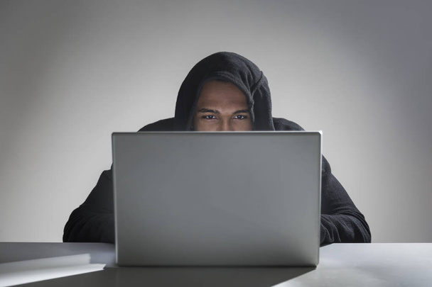 African American hacker in a hoodie - Fotó, kép