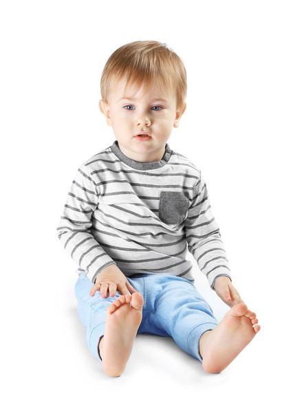 Cute little boy sitting on white background - Фото, зображення