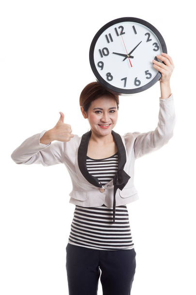 Young Asian business woman thumbs up with a clock. - Foto, Imagem