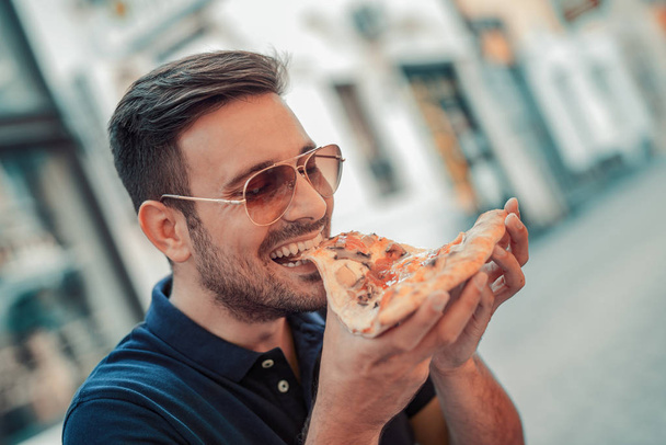 Man eating pizza  - Fotó, kép