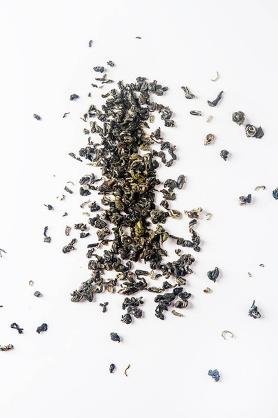 Whole leaves of dry green tea. The taste of the east. White back - Foto, Imagen