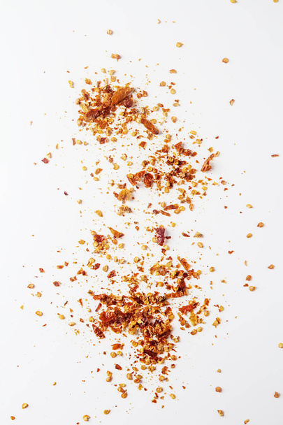 Red hot chili pepper's flakes. White background. isolated. - Фото, зображення
