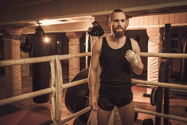 Fighter preparing for training, wrapping hands with boxing wraps - Fotoğraf, Görsel