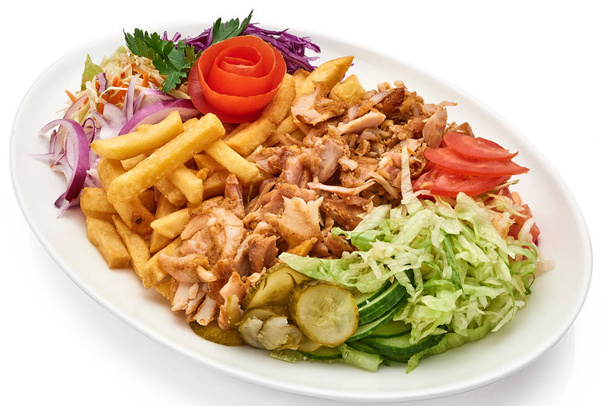 Doner kebab on a plate with french fries and salad - Photo, Image