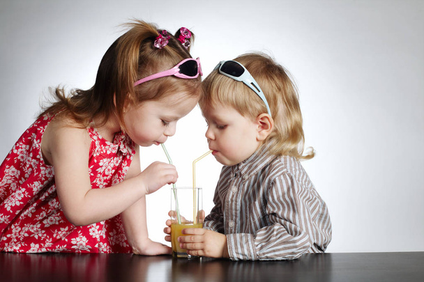 boy and girl drinking juice - 写真・画像