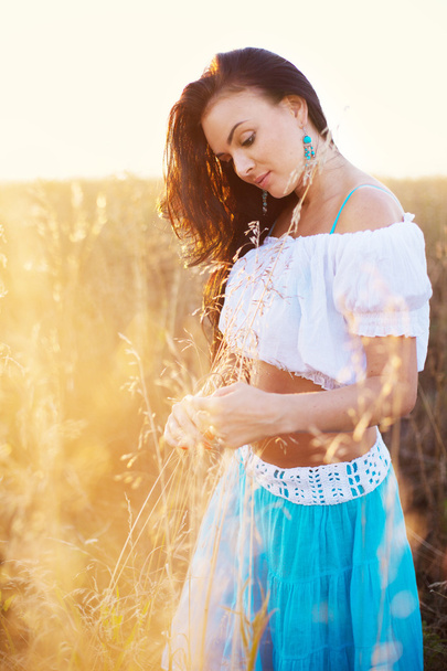 Beautiful woman in field at sunset - Photo, Image