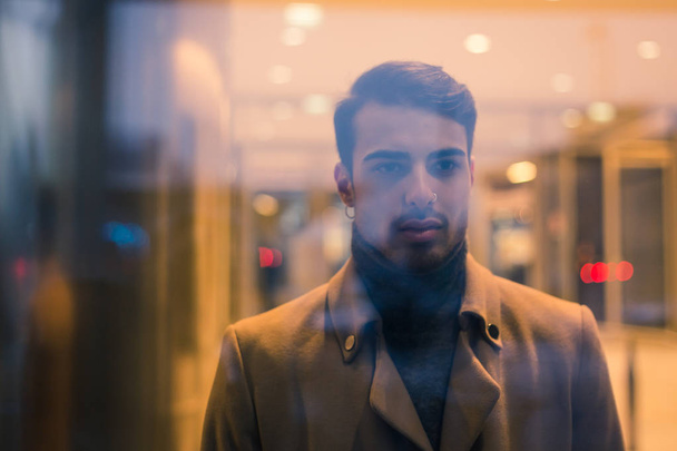 Portrait of a young man behind glass - Photo, Image
