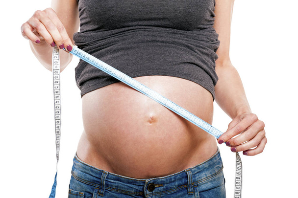 Pregnant female measuring belly, body part, child care, tummy si - Photo, Image
