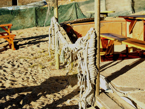 old fishing net hanging on a wooden fence - Photo, Image