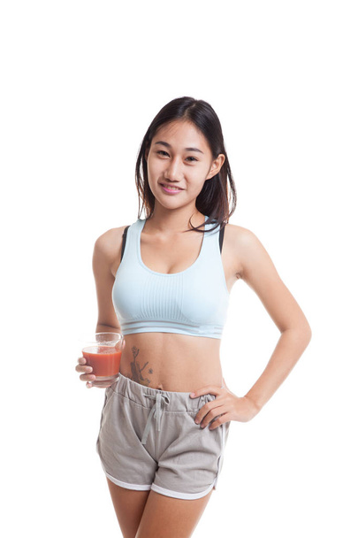 Beautiful healthy Asian girl with tomato juice. - Foto, Imagen