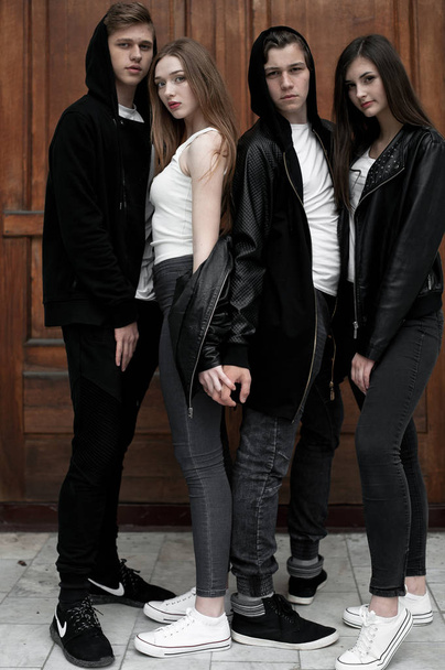Young elegant trendy friends outdoors, wearing black and white clothing - Zdjęcie, obraz