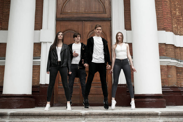 Young elegant trendy friends outdoors, wearing black and white clothing - Photo, Image