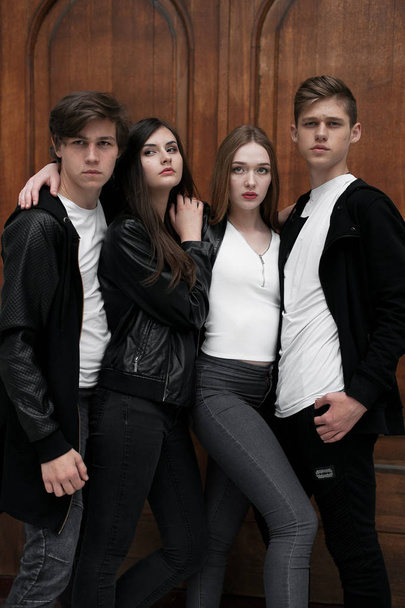 Young elegant trendy friends outdoors, wearing black and white clothing - Photo, image