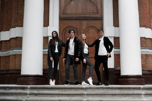 Young elegant trendy friends outdoors, wearing black and white clothing - Photo, Image