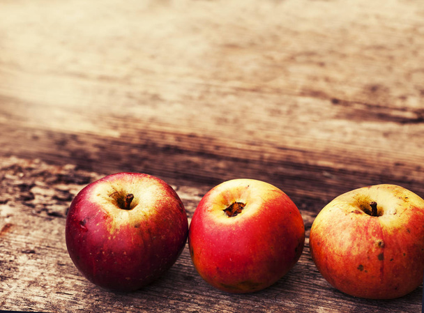red apples on wooden table - 写真・画像