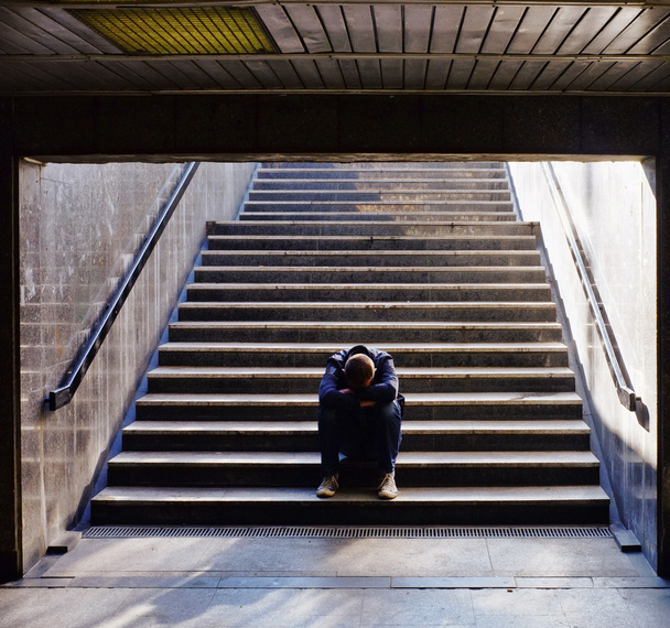 Lonely man sitting on the stairs - Φωτογραφία, εικόνα