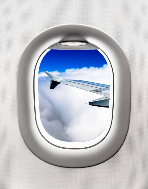 View of aircraft wing and clouds from airplane window - Photo, Image