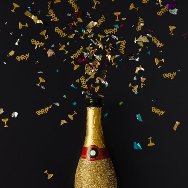 Golden champagne party bottle with confetti  - Φωτογραφία, εικόνα