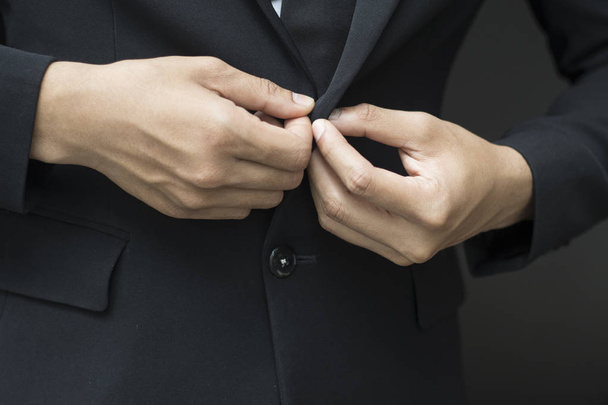 business man buttoning or unbuttoning expensive suit jacket - Fotó, kép
