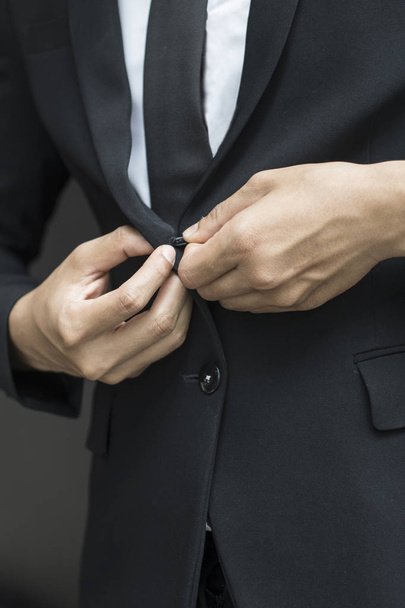 business man buttoning or unbuttoning expensive suit jacket - Fotoğraf, Görsel