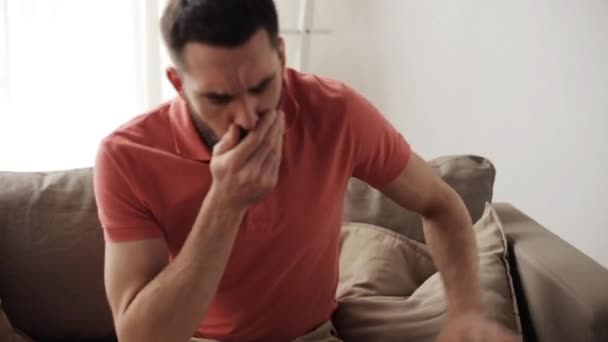 unhappy sick man coughing at home - Záběry, video