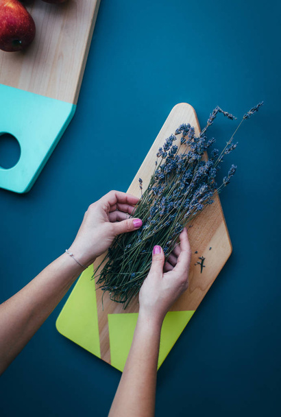 Woman put herbs on cutting board - 写真・画像