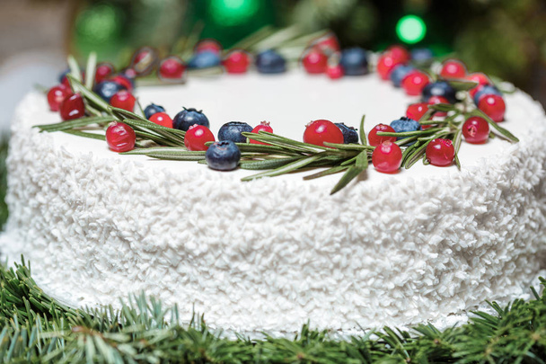 Christmas cake with berries on the background of fir branches - Photo, Image