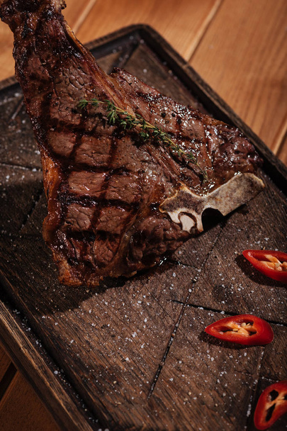 Top view of tasty steak lying on a table - Zdjęcie, obraz