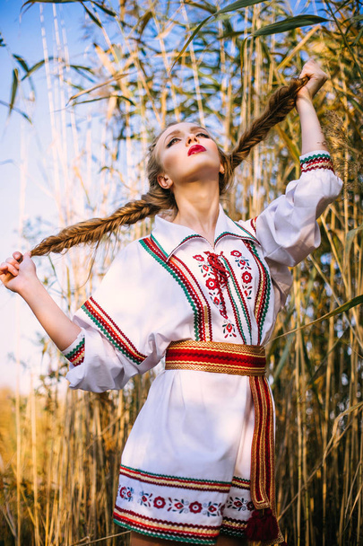 Young girl on the summer field  in national Belarus clothes - Photo, Image