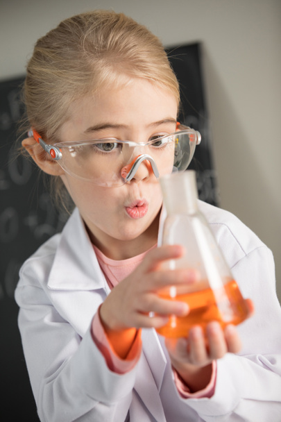 Girl holding flask with reagent  - Photo, Image