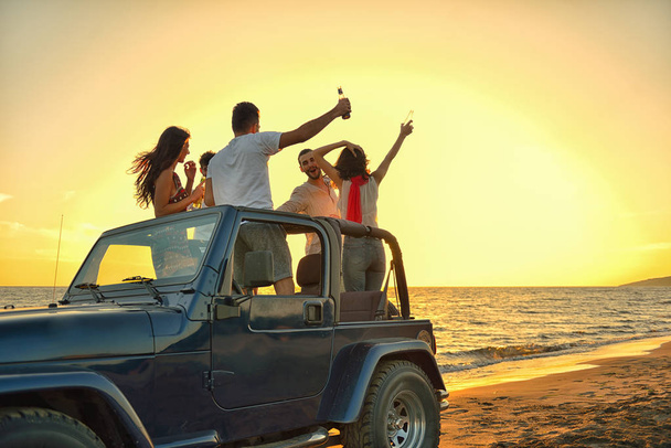 young people having fun in car at the beach  - Φωτογραφία, εικόνα