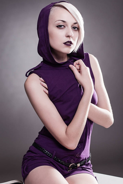 young girl with short hair in a jumpsuit with a hood - Foto, imagen